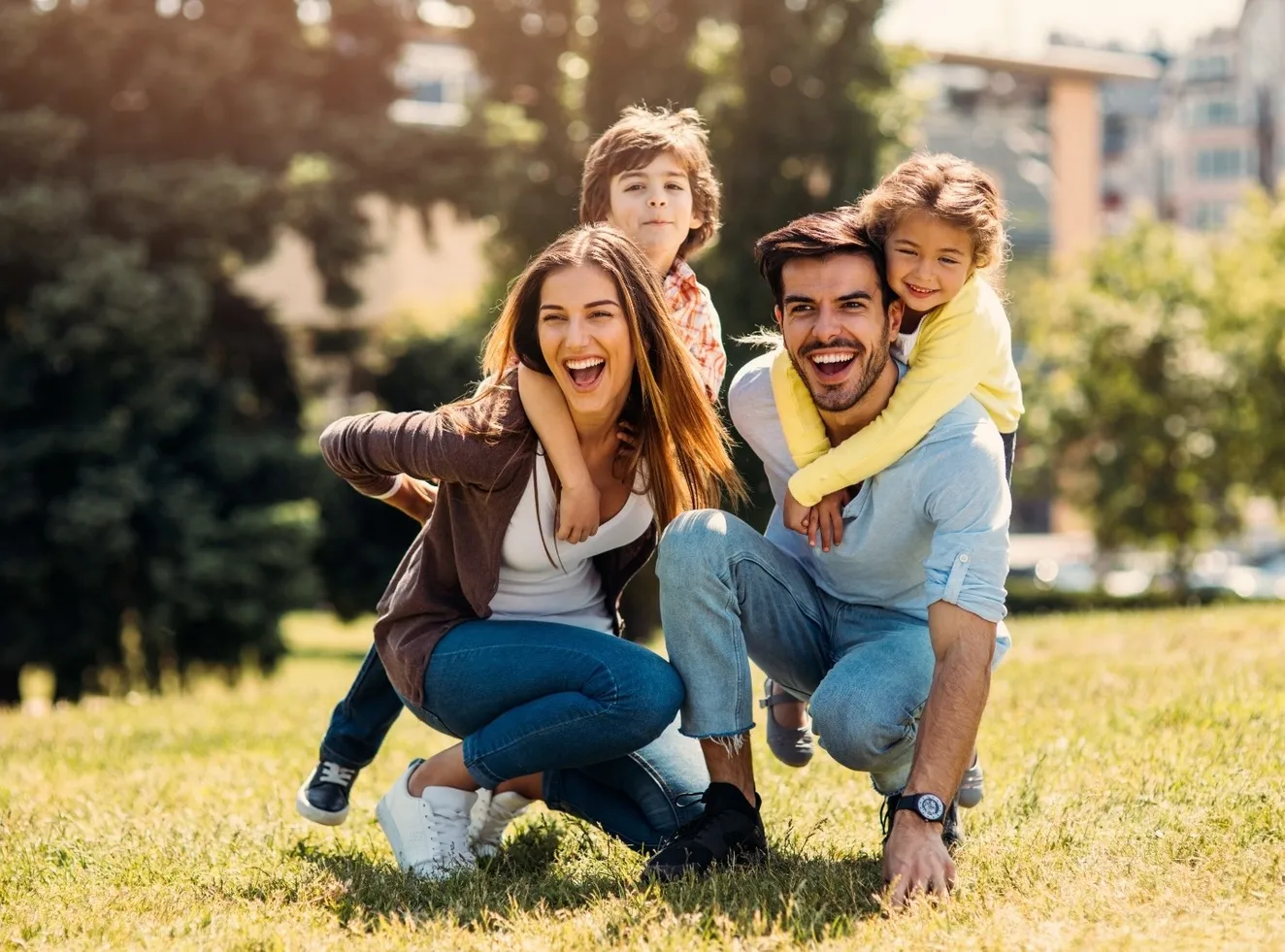 Smiling group portrait of three young adults outdoors used for lifestyle or patient-focused dental marketing imagery