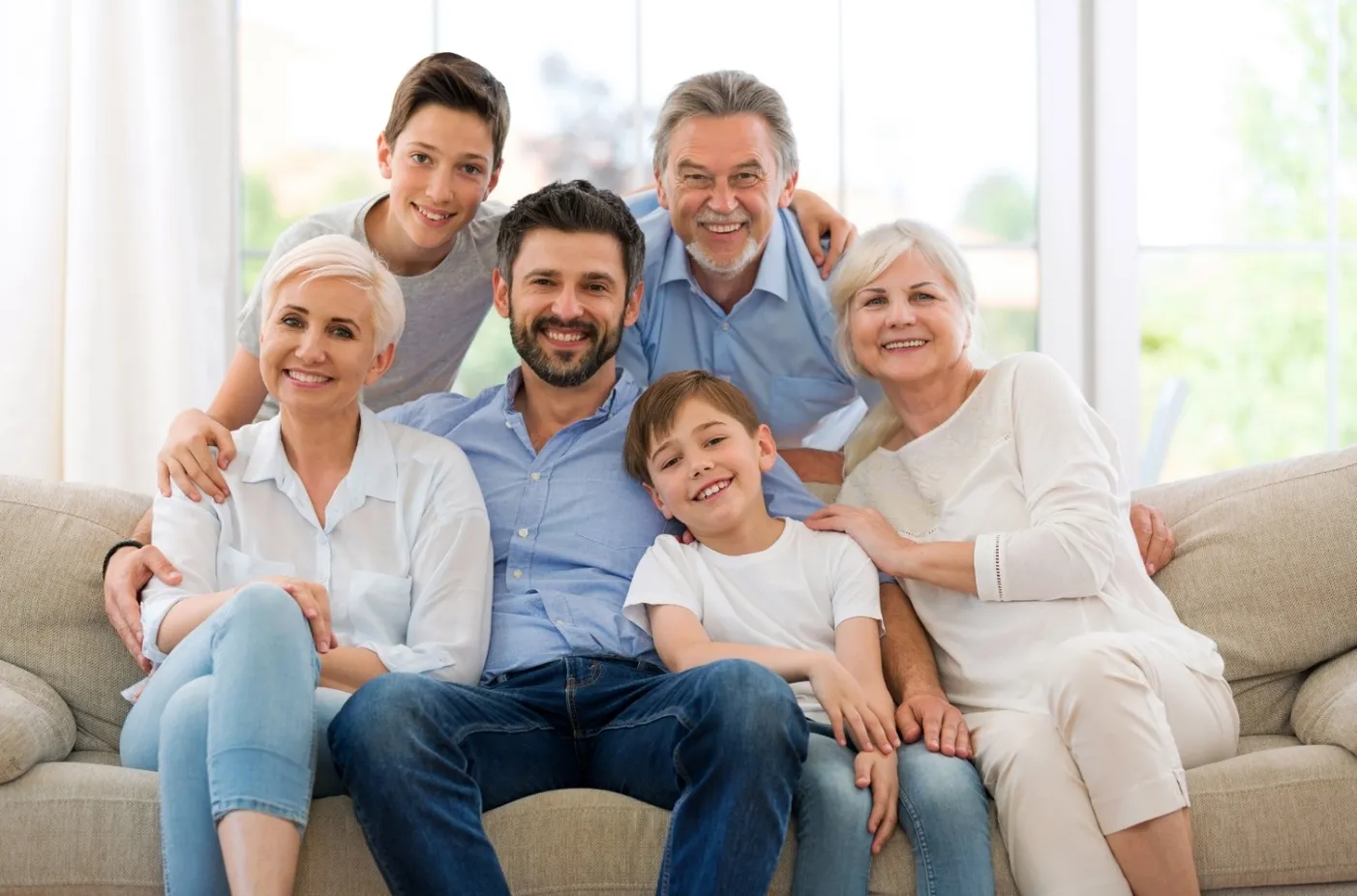 Smiling multigenerational family portrait used for patient-focused dental marketing or community-oriented healthcare imagery