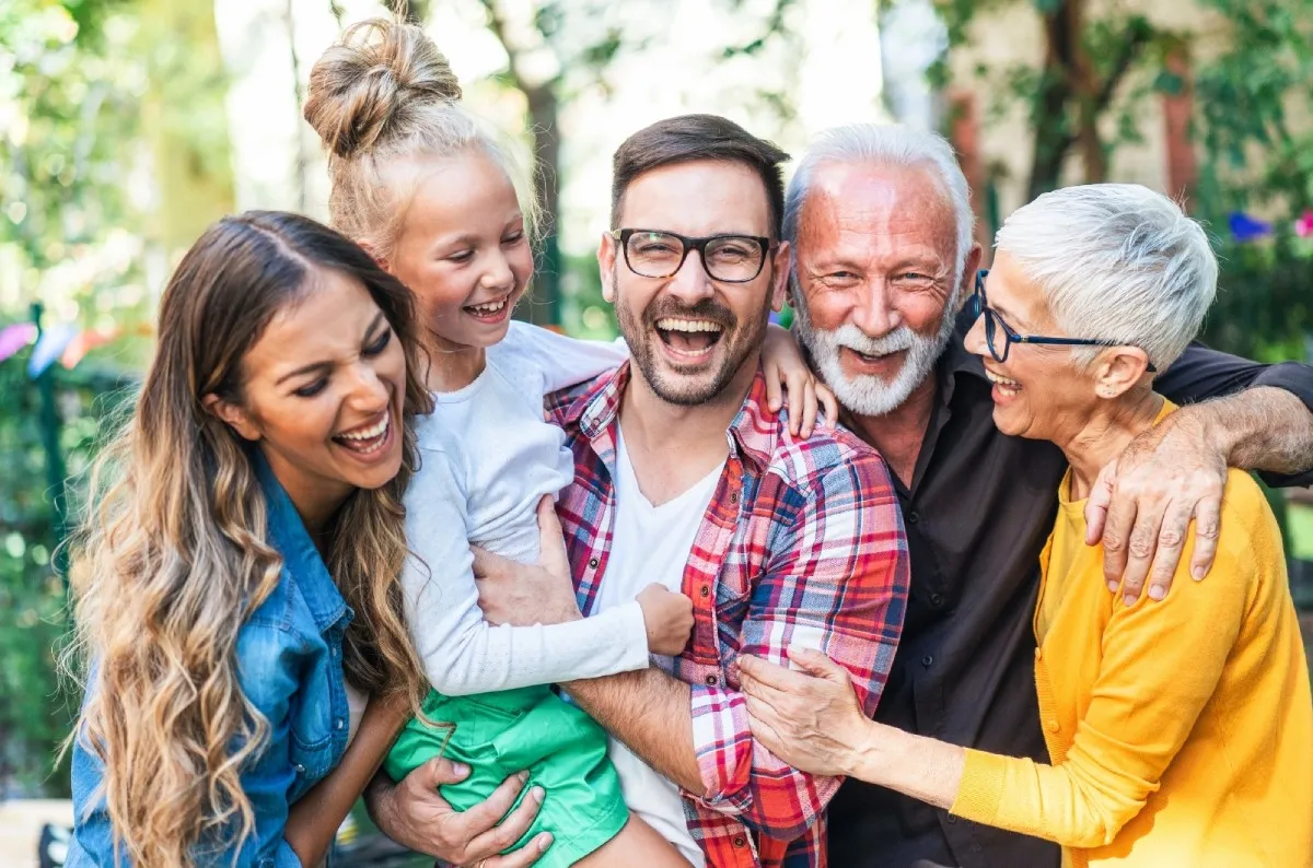 Group of smiling older adults gathered together, used for community-focused or family dental marketing imagery