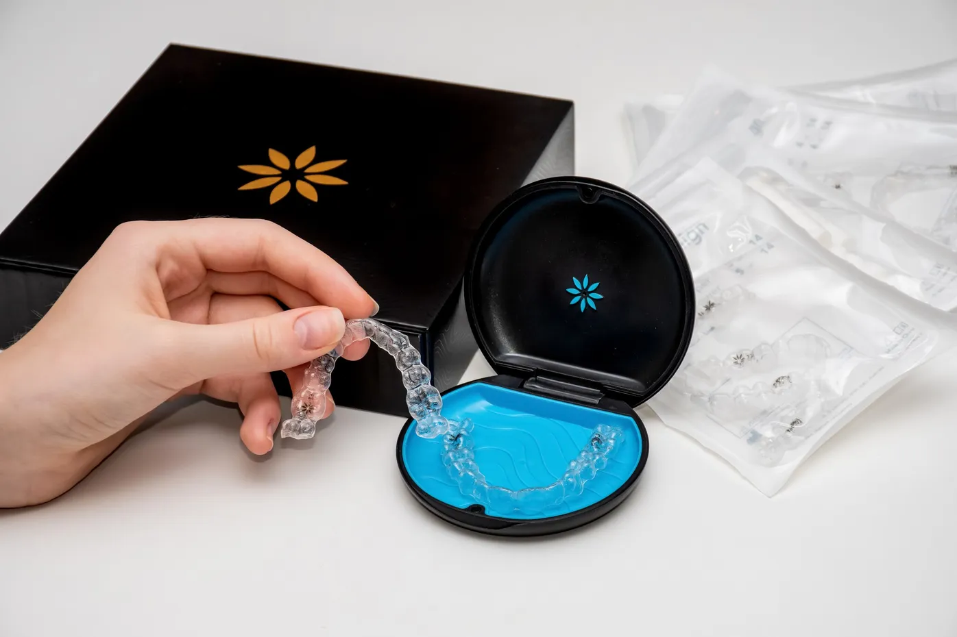 Clear aligner case opened to show blue interior and storage for removable orthodontic trays