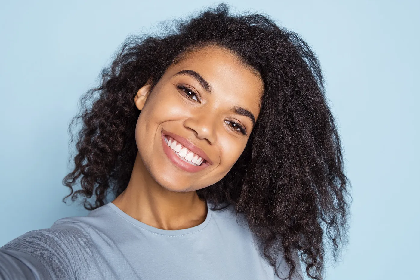Smiling woman portrait used for dental marketing or patient-focused healthcare imagery
