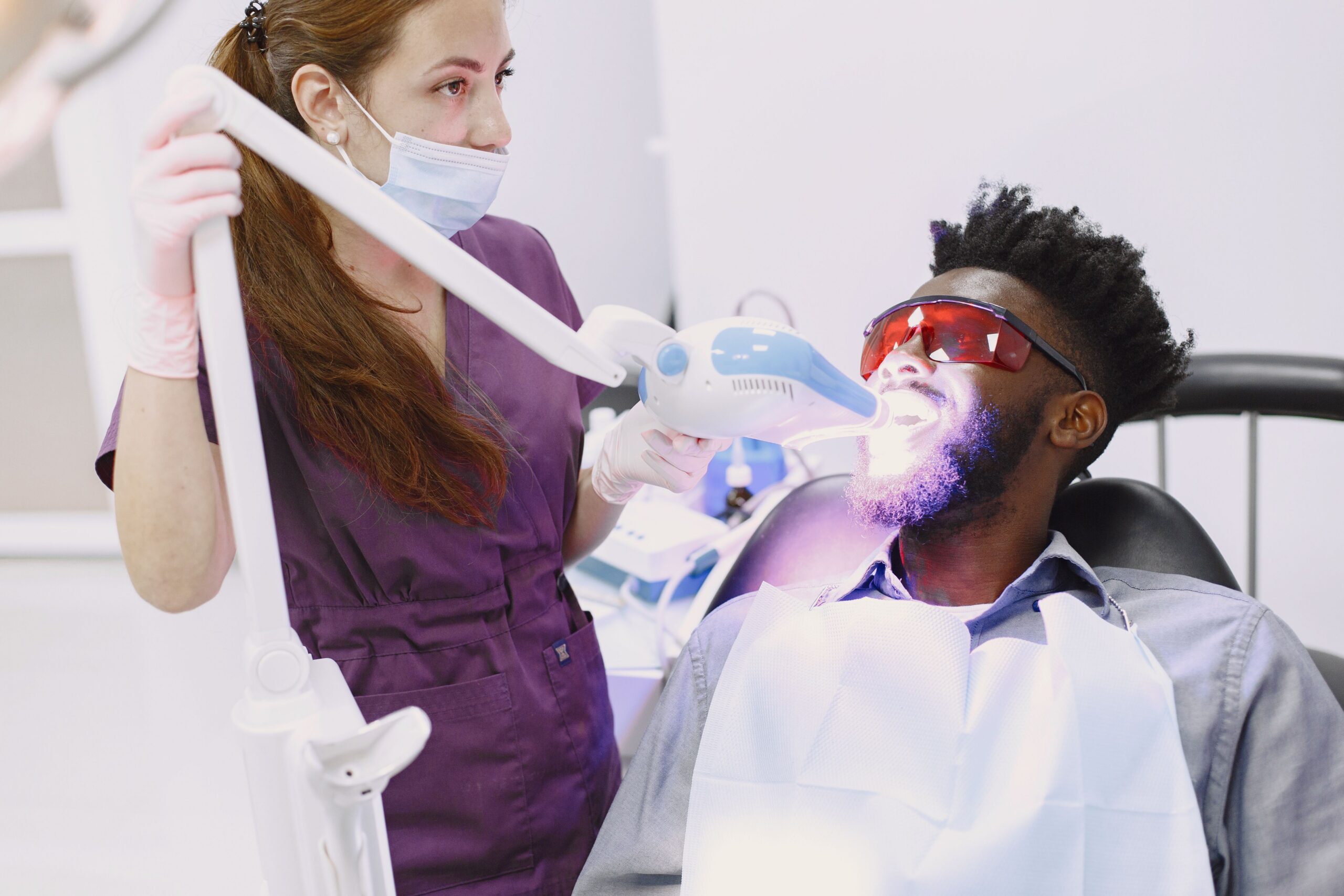 patient receiving professional teeth whitening treatment at a dental office