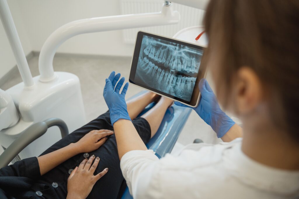 Dentist reviewing a dental X-ray with a patient during a consultation