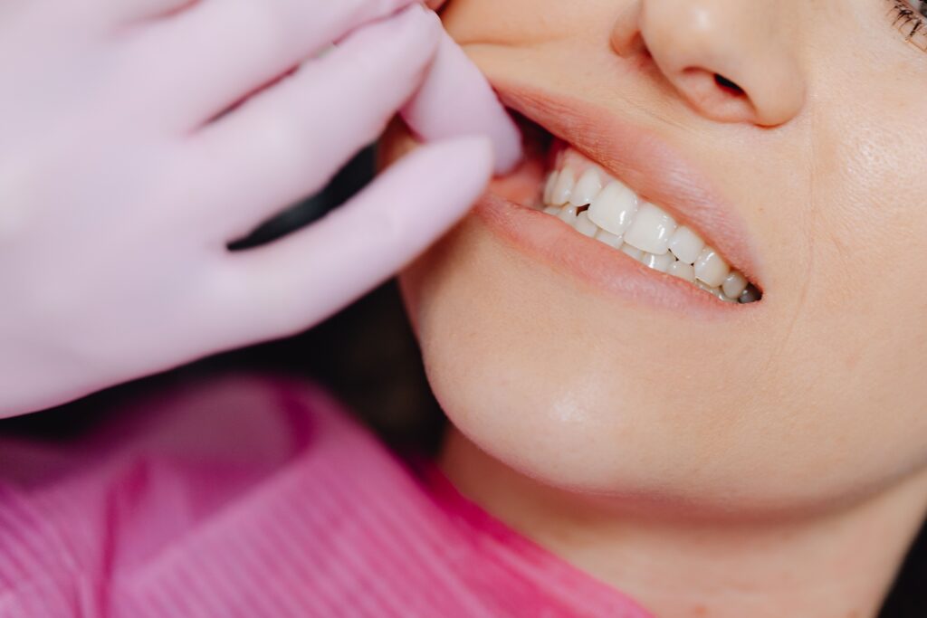 dentist examining a patient’s smile and gumline during a cosmetic dental evaluation